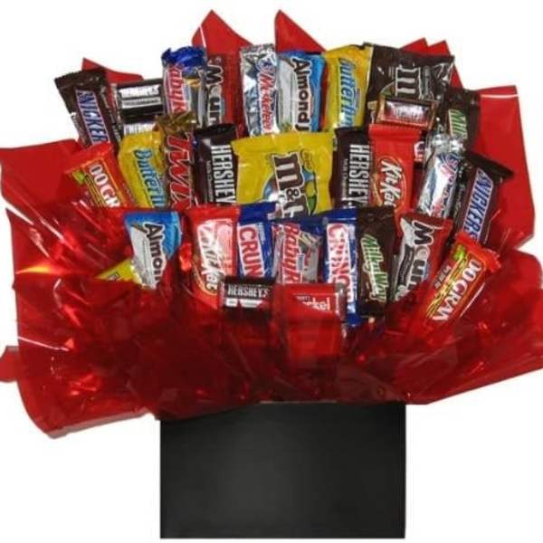 Assorted candy bars arranged in red wrapping with a black box base