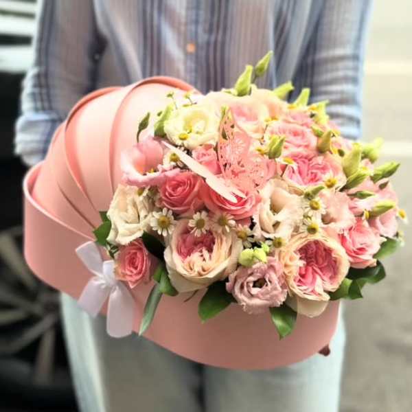 Pink rose bouquet in a round pink hatbox with a white ribbon