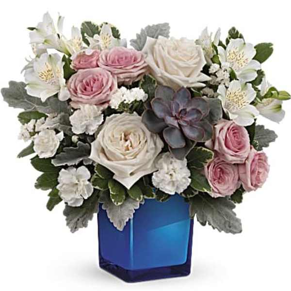 Pink and white roses with white alstroemeria in a blue vase