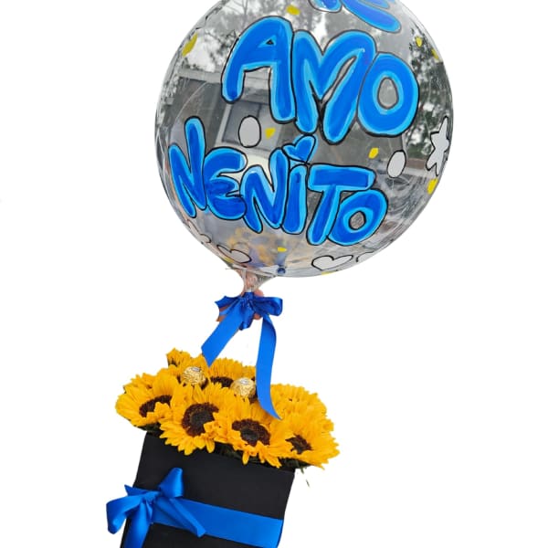 Sunflower arrangement in a black box with a clear balloon reading "Amo Nenito"