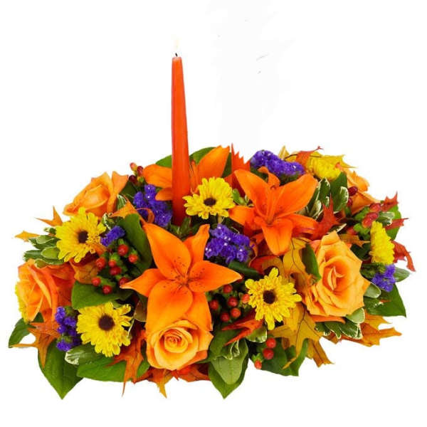Orange and yellow floral centerpiece with a tall orange candle