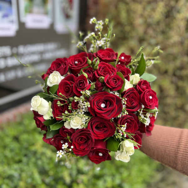 Bouquet of red and white roses with small filler flowers
