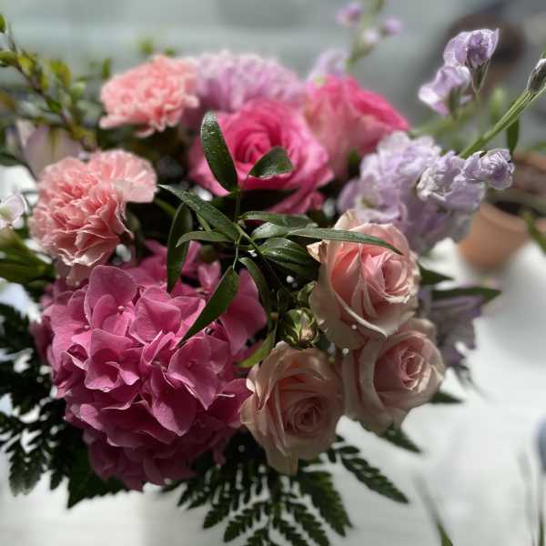 Pink and lavender bouquet with roses, hydrangea, and carnations