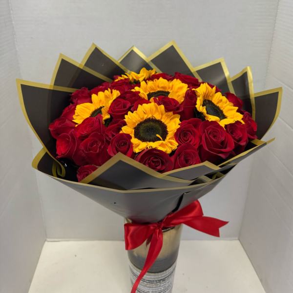 Bouquet of red roses and yellow sunflowers wrapped in black paper