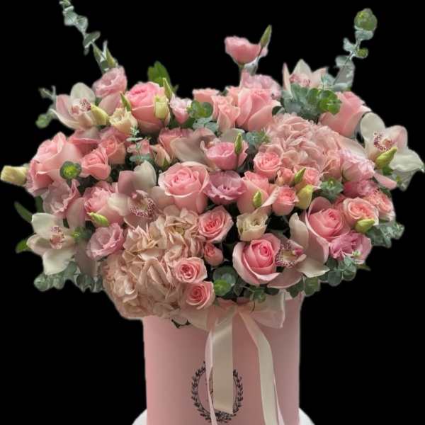 Pink rose and orchid arrangement in a pink hat box with ribbon