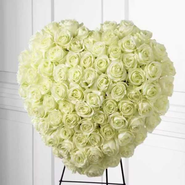 Heart-shaped bouquet of pale cream roses on a stand