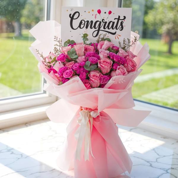 Pink rose bouquet with a "Congrats" card and ribbon wrap