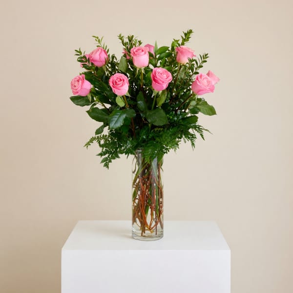 Pink roses arranged in a clear glass vase