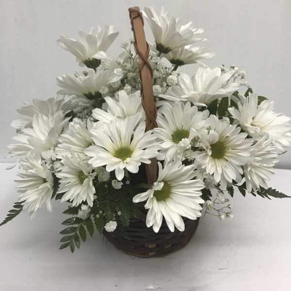 White daisy bouquet in a woven basket with a handle