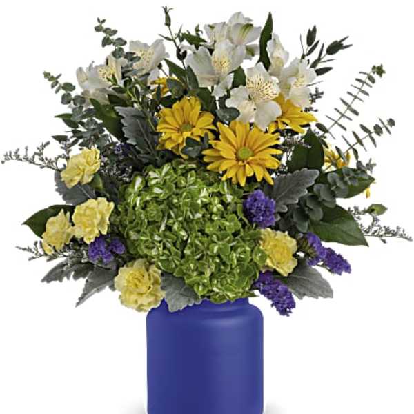 Bouquet of white and yellow flowers in a blue vase
