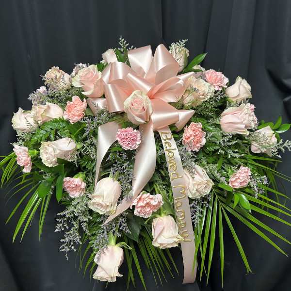 Pink and white rose spray with a satin bow and memorial ribbon