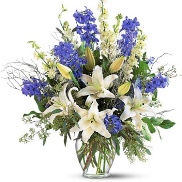 Blue and white lilies in a clear glass vase
