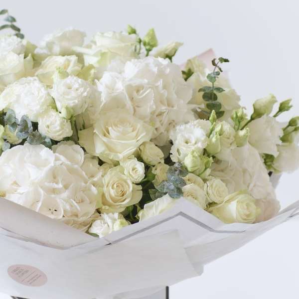 Large bouquet of white roses and hydrangeas with eucalyptus