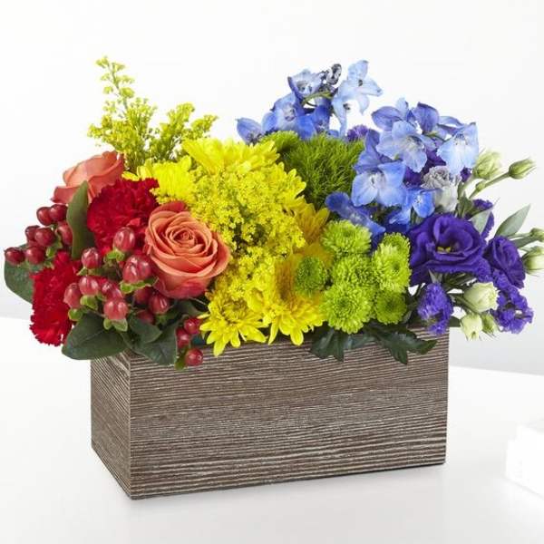 Colorful mixed flower arrangement in a rectangular wooden box