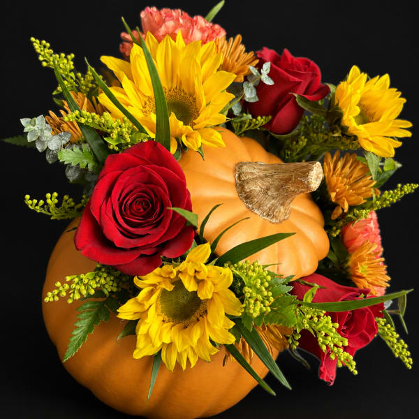 Pumpkin arrangement with red roses and yellow sunflowers