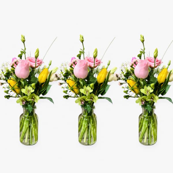 Pink and yellow mixed flower bouquet in a glass vase