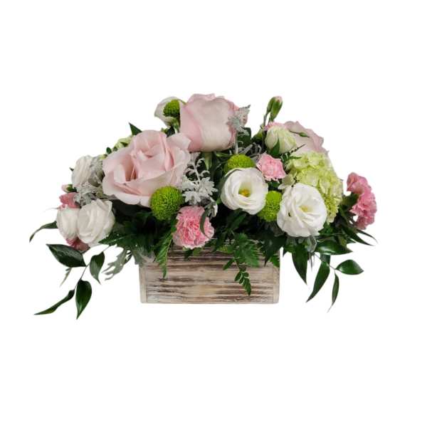 Pink and white floral arrangement in a wooden box