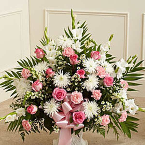 Pink and white floral standing spray with a pink ribbon bow