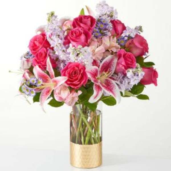 Bouquet of pink roses and lilies in a glass vase