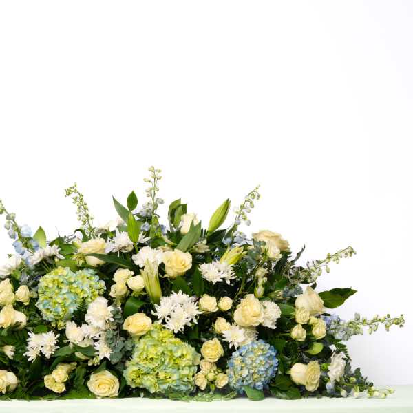 Our Gentle Thoughts Collection: Full Casket Spray in White and Blue