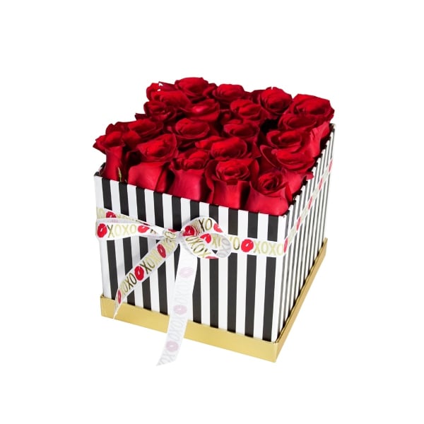 Red roses arranged in a striped gift box with a ribbon