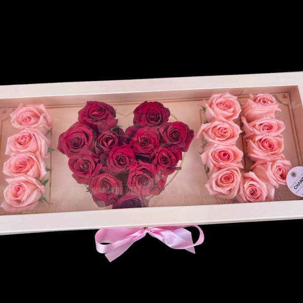 Heart-shaped rose arrangement in a white gift box with pink ribbon
