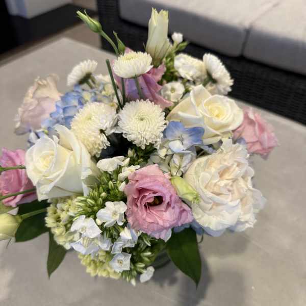 Bouquet of white, pink, and blue flowers in a vase