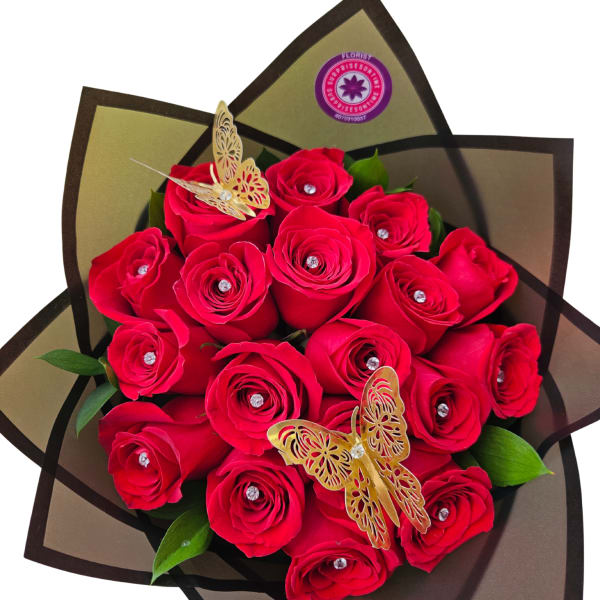 Bouquet of red roses wrapped in dark paper with butterfly decorations
