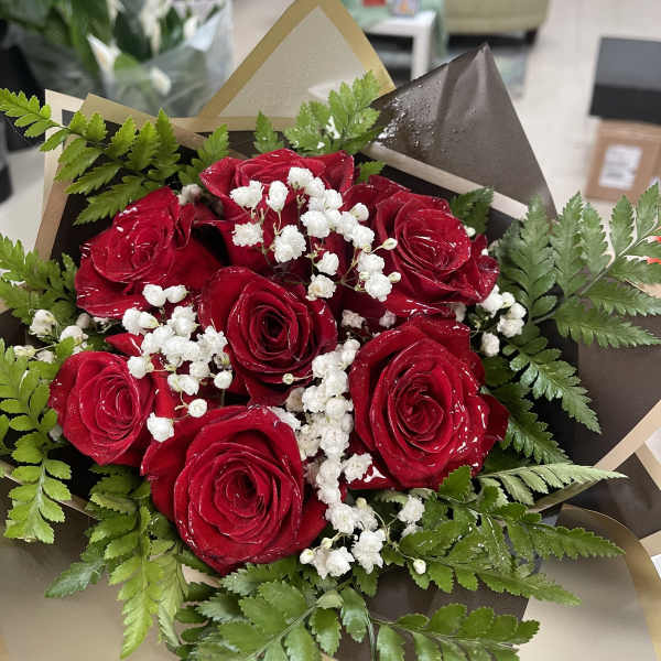 Bouquet of red roses with white baby's breath and greenery