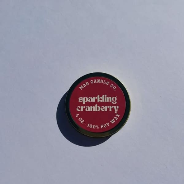 Round tin candle labeled sparkling cranberry