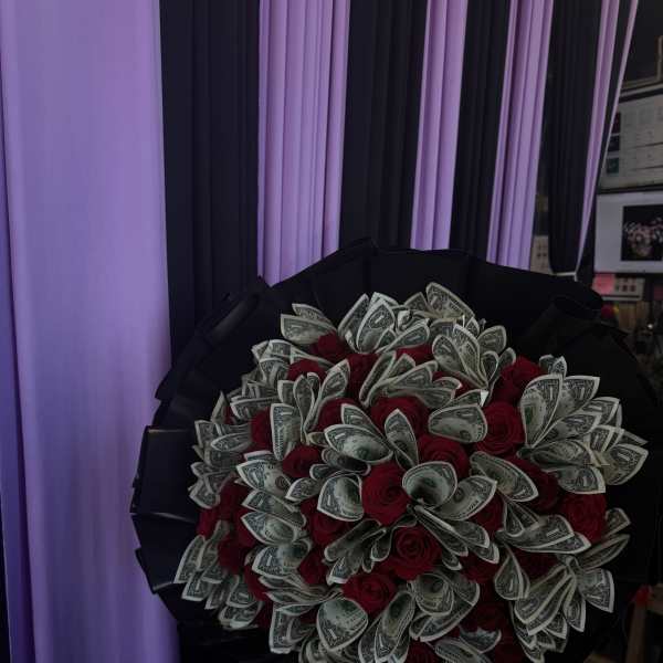 Bouquet of red roses mixed with folded dollar bills