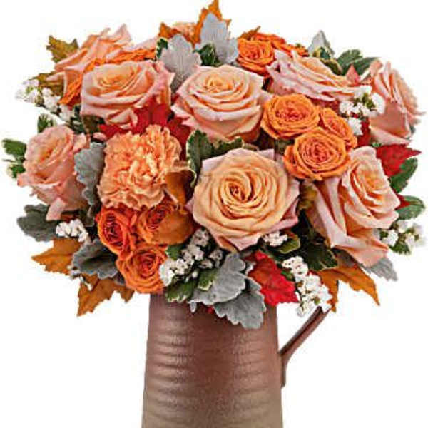 Peach and orange rose bouquet in a brown vase