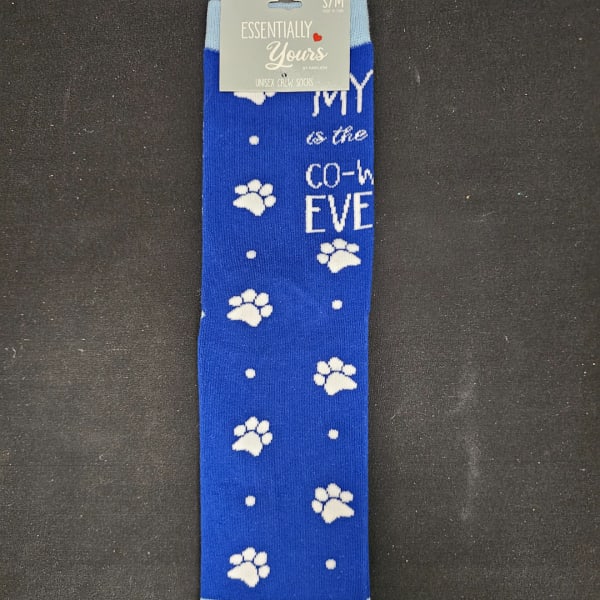 Blue crew socks with white paw prints and text on a retail hanger