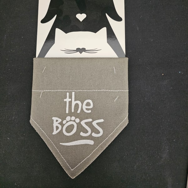 Fabric pocket sign reading "the BOSS" with a cat graphic card behind it