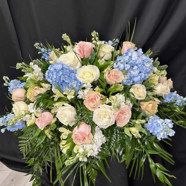 Large bouquet of pink and white roses with blue hydrangeas