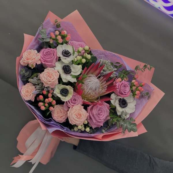 Hand-tied bouquet of pink and lavender roses with white anemones