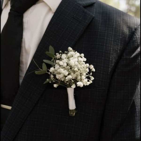 White boutonniere on a dark suit jacket