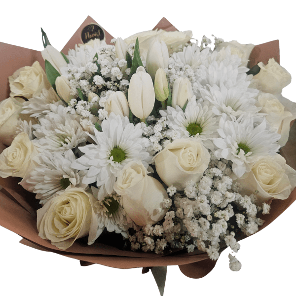 White roses and daisies with tulips in a wrapped bouquet