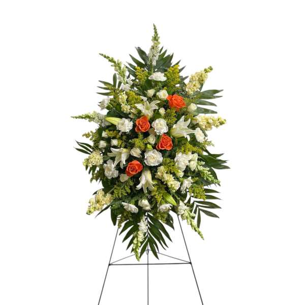 Standing floral spray with white lilies, orange roses, and white blooms