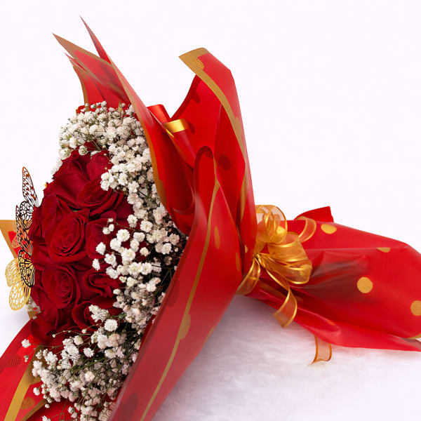 Bouquet of red roses with white baby's breath in red wrapping