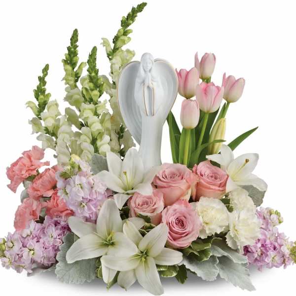 Pink and white floral arrangement with a white angel figurine