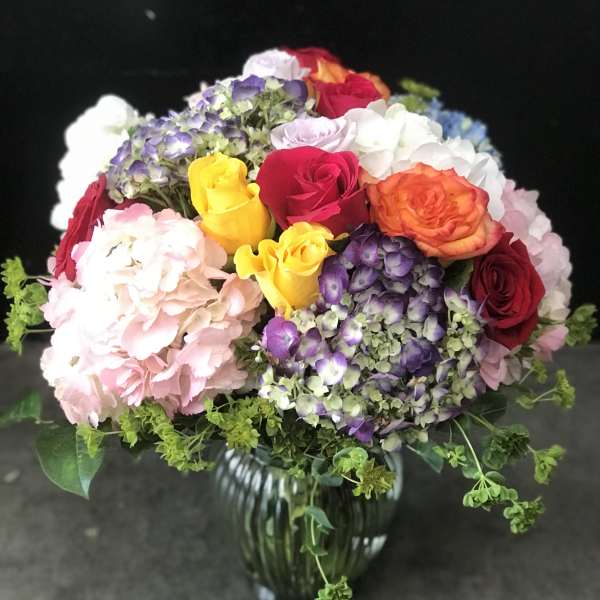 Mixed bouquet of roses and hydrangeas in a glass vase