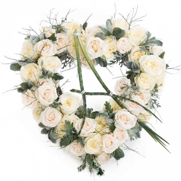 Heart-shaped bouquet of cream roses with muted greenery