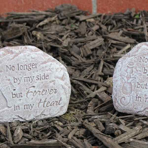 Two memorial stones engraved with angel designs and a remembrance message