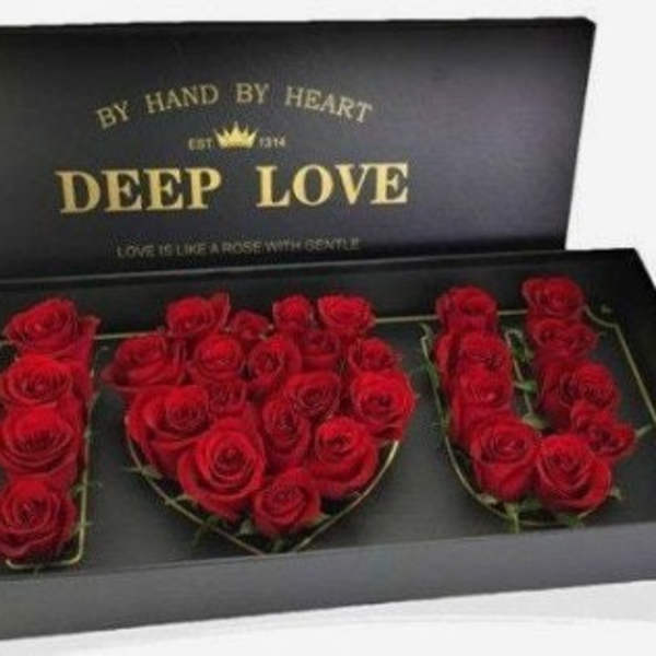 Red roses arranged in a black gift box spelling "DEEP LOVE"