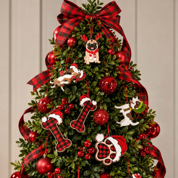 Decorated Christmas tree with red ornaments, plaid ribbon, and dog ornaments