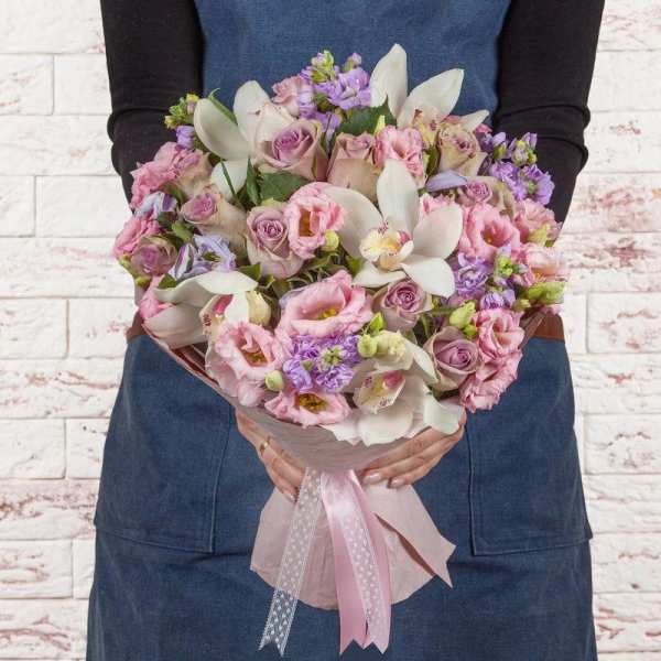Handheld bouquet of pink roses and white orchids with a pink ribbon wrap