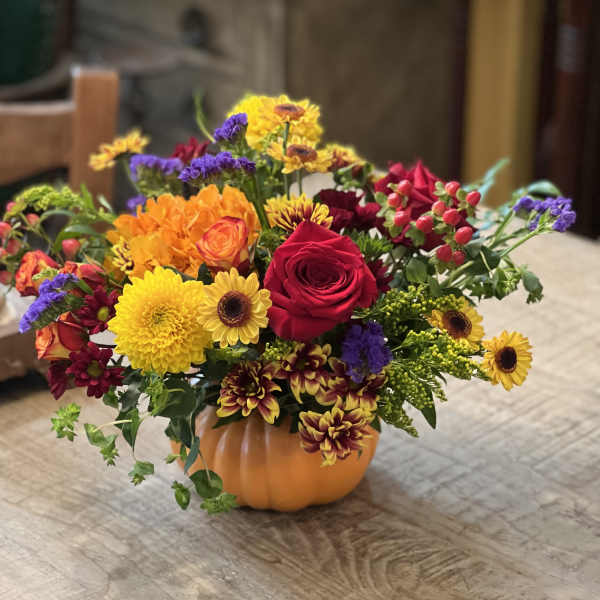 Colorful mixed bouquet in a small orange pumpkin container