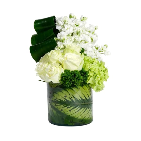 White roses and hydrangeas in a green painted glass vase