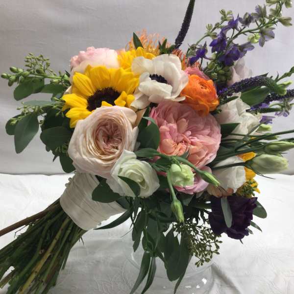 Mixed bouquet with sunflowers, roses, and white blooms